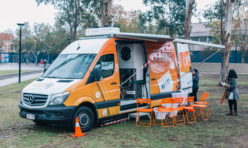 Orange van with washing machines inside