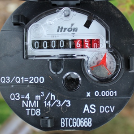 Itron brand meters have the serial number printed at the bottom of the meter face.