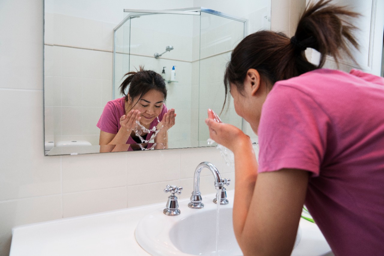 Girl washing her face.