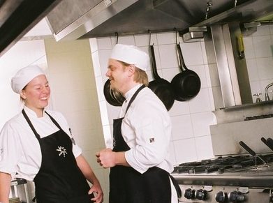Two cooks in  commercial kitchen