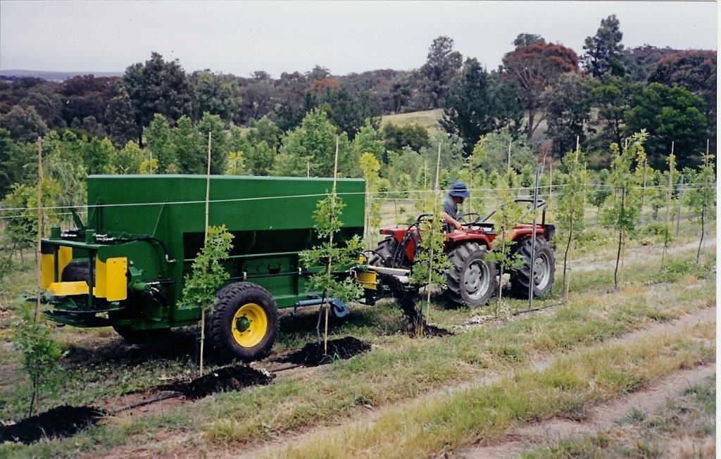 Tractor distributing biosolids for land use